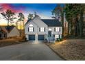 Two-story house with gray shutters, a two-car garage, and a deck at dusk at 2713 Windsor Nw Ct, Kennesaw, GA 30144