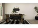 Modern dining room with wood table, black chairs, and a stylish rug at 2801 Habibi Ct, Buford, GA 30519