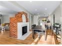 Bright dining room with exposed brick fireplace and hardwood floors at 2662 Memorial Se Dr, Atlanta, GA 30317