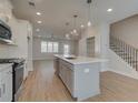 Modern kitchen with island, stainless steel appliances, and hardwood floors at 4822 Floydwood Ln, Mableton, GA 30126