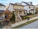 Two-story home on tree lined street with brick front steps at 627 Mead Se St, Atlanta, GA 30312