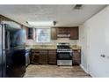 Full view of kitchen with appliances and wood-look flooring at 3727 Conley Downs Ln, Decatur, GA 30034
