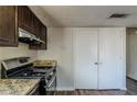 Kitchen features dark brown cabinets and granite countertops at 3727 Conley Downs Ln, Decatur, GA 30034