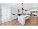 Modern white kitchen with large island and hardwood floors at 622 Bellemeade Nw Ave # 9, Atlanta, GA 30318