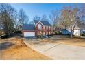 Two-story house with driveway and mature trees at 11060 Pinewalk Forest Cir, Alpharetta, GA 30022