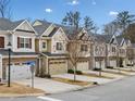 Row of townhouses with gray roofs, landscaping, and a street at 1024 Candela Ln, Smyrna, GA 30082