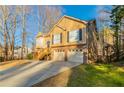 Two-story house with double garage and a long driveway at 2895 Ivy Mill Dr, Buford, GA 30519