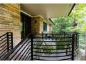 Inviting front porch with stone wall and metal railing at 4373 Wieuca Ne Rd, Atlanta, GA 30342