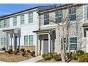 Two story townhome with gray and white siding, landscaping, and gray front doors at 585 Mcwilliams Se Rd # 807, Atlanta, GA 30315