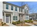 Two-story townhome with gray and white siding, landscaping, and a gray front door at 585 Mcwilliams Se Rd # 807, Atlanta, GA 30315