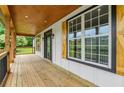 Inviting front porch with wooden flooring and a view of the yard at 4107 Old Suwanee Rd, Buford, GA 30518