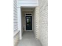 Stylish front entrance with a black door, white brick accents and a welcoming covered porch area at 1250 Winterhaven Dr, Cumming, GA 30041