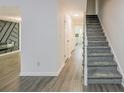 Gray carpeting on stairs, light gray walls, and wood-look flooring at 2106 Childress Sw Dr, Atlanta, GA 30311