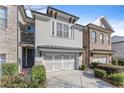 Charming townhome with light brick and a 2-car garage at 3939 Glenview Club Ln, Duluth, GA 30097