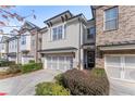 Beautiful townhome with gray and brick exterior, and landscaping at 3939 Glenview Club Ln, Duluth, GA 30097