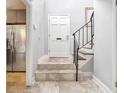 Bright entryway with tile flooring, staircase, and view of kitchen at 868 E Ponce De Leon Ave, Decatur, GA 30030