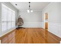 Dining room with hardwood floors and a view into kitchen area at 2421 Merrion Park Ct, Dacula, GA 30019