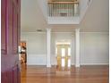 Two-story foyer with hardwood floors and a view to the Gathering room at 2421 Merrion Park Ct, Dacula, GA 30019