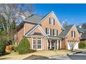 Two-story brick home with a gray roof and landscaped front yard at 1052 Brookhaven Ne Walk, Brookhaven, GA 30319