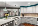 Modern kitchen with gray cabinets and quartz countertops at 200 River Vista Dr # 427, Atlanta, GA 30339