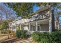 Two story gray house with a front porch, viewed from the street at 2698 Farmstead Se Rd, Smyrna, GA 30080