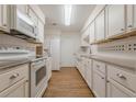 Well-lit kitchen with white cabinets and modern appliances at 2698 Farmstead Se Rd, Smyrna, GA 30080