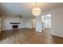 Spacious living room with a fireplace and updated light fixture at 2698 Farmstead Se Rd, Smyrna, GA 30080