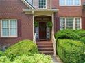 Inviting front entrance with brick steps and lush landscaping at 156 Vine Creek Dr, Acworth, GA 30101