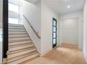 Modern staircase with light wood steps and dark accent wall at 160 Cedarwood Ln, Roswell, GA 30075