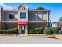 Townhouse exterior featuring a red awning and manicured landscaping at 3301 Henderson Mill Rd, Atlanta, GA 30341