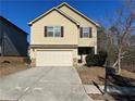 Two-story house with beige siding, attached garage, and a small front yard at 606 Grenier Ter, Lawrenceville, GA 30045