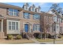 Brick townhouse exterior with blue door, steps, and landscaping at 705 Pecan Knoll Dr, Marietta, GA 30008