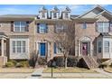 Brick townhouse exterior with blue door, steps, and landscaping at 705 Pecan Knoll Dr, Marietta, GA 30008