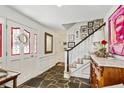 Bright entryway with slate floor, staircase and decorative wall at 3089 Castaway Ln, Atlanta, GA 30341