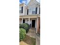 Townhome entrance with landscaping, covered porch, and a brick exterior at 930 Parkway Rd, Union City, GA 30291