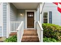 Close-up of a charming front entrance with a wooden door, brick steps, and white railing at 3616 Longfellow Trl, Marietta, GA 30062
