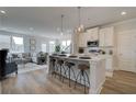 Open concept kitchen with white cabinets, island seating, and stainless steel appliances at 226 Depot Landing Rd # 56, Auburn, GA 30011