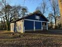 Side view of a charming blue house with a yard at 1116 Northwest Nw Dr, Atlanta, GA 30318