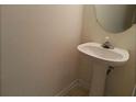 Small half bathroom with pedestal sink and mirror at 2962 Vining Ridge Ln, Decatur, GA 30034