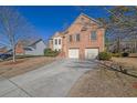 Brick two-story house with attached two-car garage and driveway at 3643 Southland Ne Dr, Buford, GA 30519
