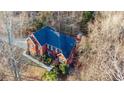 Two-story house, dark roof, surrounded by trees at 7715 Bold Springs Xing, Cumming, GA 30041