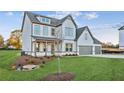 Two-story farmhouse with gray accents and a three-car garage at 2799 Porches Ln, Dacula, GA 30019