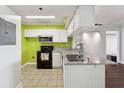Granite countertops, white cabinets and black appliances in this updated kitchen at 795 Hammond Dr # 1407, Atlanta, GA 30328