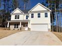 Charming two-story home with a brick-accented porch and a pristine two-car garage at 195 Ridgecrest Way, Stockbridge, GA 30281