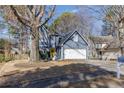 Beautiful two-story blue home with a yellow front door, set amidst mature trees and a well-kept lawn at 1878 Hamby Place Nw Dr, Acworth, GA 30102