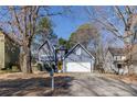 Inviting blue home with a yellow front door, set back on a spacious lot with mature trees at 1878 Hamby Place Nw Dr, Acworth, GA 30102
