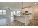 Modern kitchen with white cabinets, granite counters, and island at 214 Depot Landing Rd # 62, Auburn, GA 30011