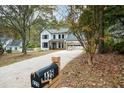 Two-story white house with a long driveway and mailbox; located in a wooded area at 425 Shepard Sw Dr, Marietta, GA 30064