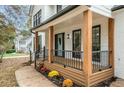 Inviting front porch with wooden posts, black railing, and a light teal door at 425 Shepard Sw Dr, Marietta, GA 30064