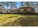 Beautiful brick home with green shutters and a well-maintained lawn at 2540 Thornton Dr, Atlanta, GA 30349